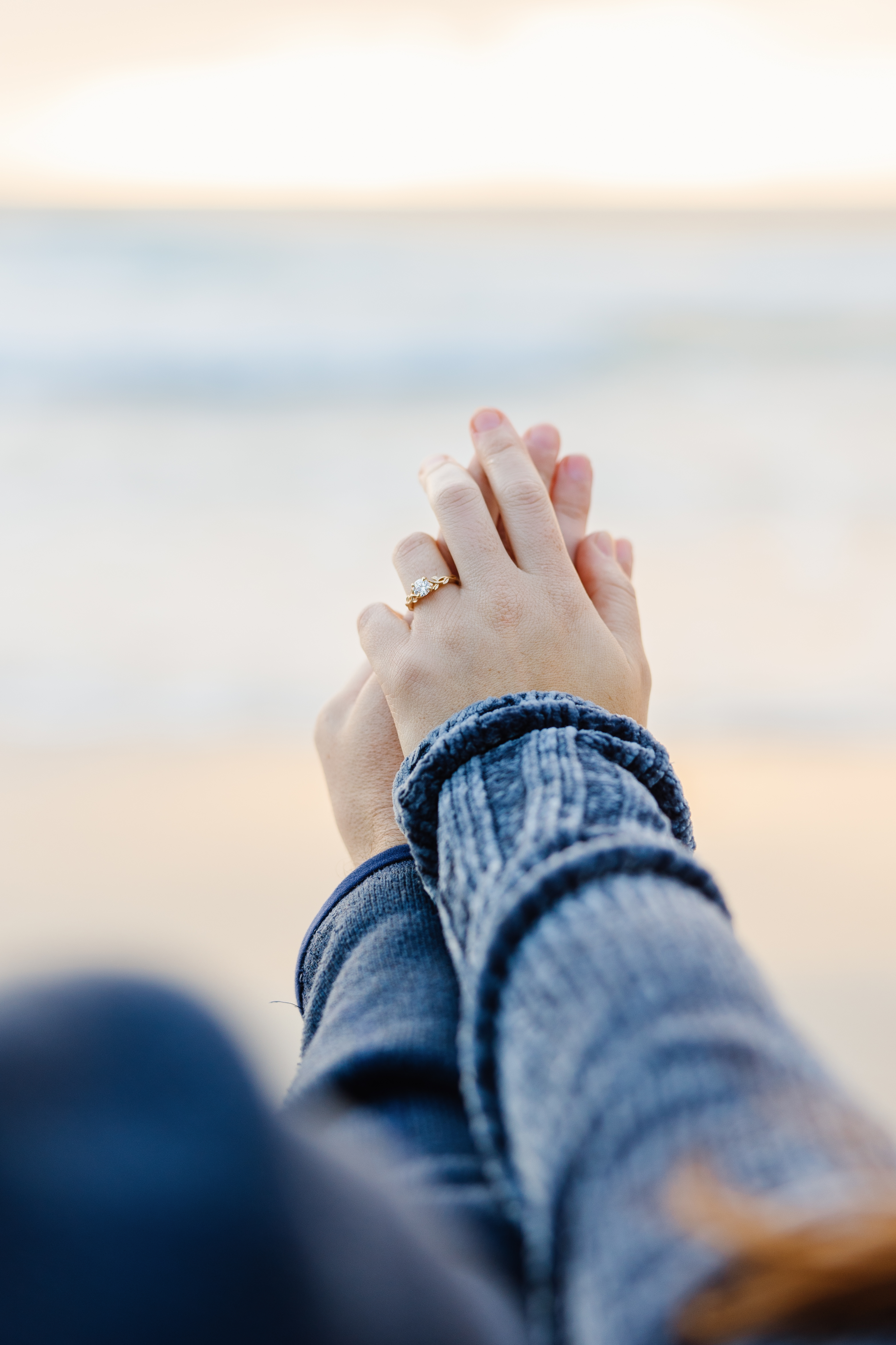 Hands clasped showing engagement ring